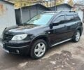 Черный Мицубиси Аутлендер, объемом двигателя 2.4 л и пробегом 256 тыс. км за 6900 $, фото 2 на Automoto.ua