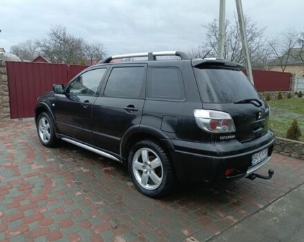 Черный Мицубиси Аутлендер, объемом двигателя 2 л и пробегом 200 тыс. км за 5100 $, фото 1 на Automoto.ua