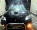 Черный Мицубиси Аутлендер, объемом двигателя 2 л и пробегом 170 тыс. км за 9000 $, фото 1 на Automoto.ua
