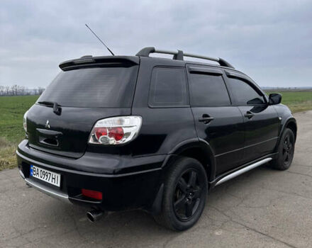 Черный Мицубиси Аутлендер, объемом двигателя 2 л и пробегом 230 тыс. км за 6300 $, фото 1 на Automoto.ua