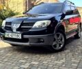 Черный Мицубиси Аутлендер, объемом двигателя 2.4 л и пробегом 250 тыс. км за 7500 $, фото 1 на Automoto.ua