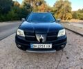 Черный Мицубиси Аутлендер, объемом двигателя 2.4 л и пробегом 255 тыс. км за 6500 $, фото 1 на Automoto.ua