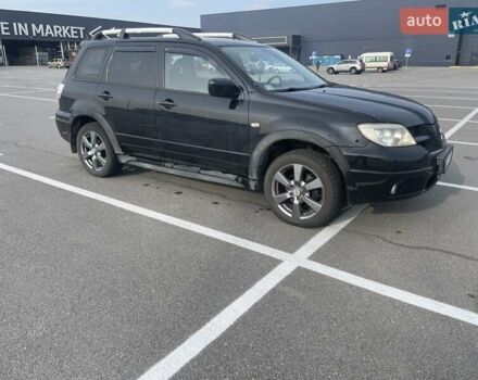 Черный Мицубиси Аутлендер, объемом двигателя 2.38 л и пробегом 180 тыс. км за 6900 $, фото 1 на Automoto.ua