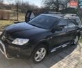 Черный Мицубиси Аутлендер, объемом двигателя 2 л и пробегом 130 тыс. км за 6400 $, фото 2 на Automoto.ua