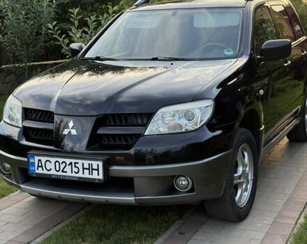 Черный Мицубиси Аутлендер, объемом двигателя 2 л и пробегом 212 тыс. км за 7400 $, фото 1 на Automoto.ua