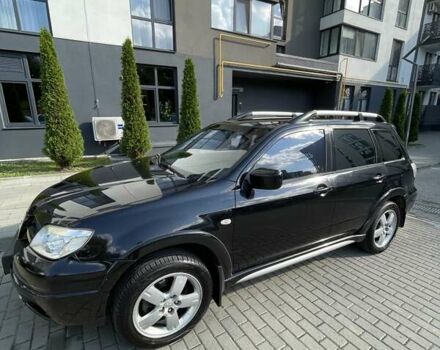 Черный Мицубиси Аутлендер, объемом двигателя 2.38 л и пробегом 310 тыс. км за 7500 $, фото 1 на Automoto.ua