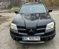Черный Мицубиси Аутлендер, объемом двигателя 2 л и пробегом 312 тыс. км за 4600 $, фото 1 на Automoto.ua