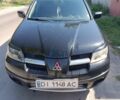 Черный Мицубиси Аутлендер, объемом двигателя 2 л и пробегом 280 тыс. км за 6700 $, фото 1 на Automoto.ua