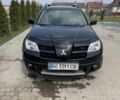 Черный Мицубиси Аутлендер, объемом двигателя 2 л и пробегом 130 тыс. км за 7100 $, фото 1 на Automoto.ua