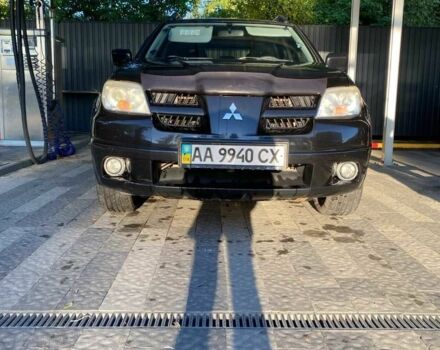 Черный Мицубиси Аутлендер, объемом двигателя 2.4 л и пробегом 219 тыс. км за 6500 $, фото 1 на Automoto.ua