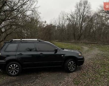Черный Мицубиси Аутлендер, объемом двигателя 2.38 л и пробегом 215 тыс. км за 5800 $, фото 1 на Automoto.ua