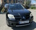 Черный Мицубиси Аутлендер, объемом двигателя 2 л и пробегом 238 тыс. км за 5500 $, фото 1 на Automoto.ua