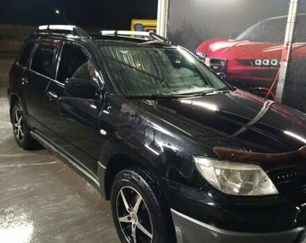 Черный Мицубиси Аутлендер, объемом двигателя 2 л и пробегом 295 тыс. км за 5300 $, фото 1 на Automoto.ua