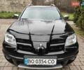 Черный Мицубиси Аутлендер, объемом двигателя 2 л и пробегом 180 тыс. км за 6000 $, фото 1 на Automoto.ua