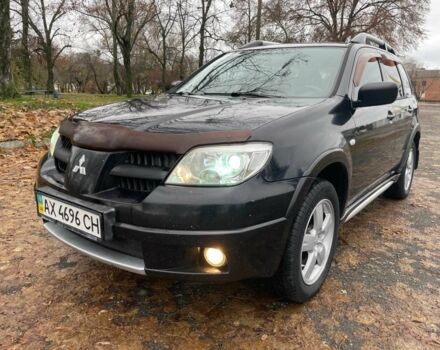 Черный Мицубиси Аутлендер, объемом двигателя 2.4 л и пробегом 213 тыс. км за 6850 $, фото 1 на Automoto.ua