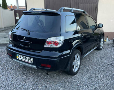 Черный Мицубиси Аутлендер, объемом двигателя 2.38 л и пробегом 118 тыс. км за 6850 $, фото 3 на Automoto.ua