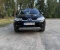 Черный Мицубиси Аутлендер, объемом двигателя 2.4 л и пробегом 208 тыс. км за 9999 $, фото 1 на Automoto.ua