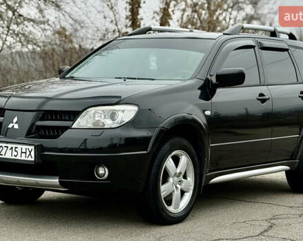 Черный Мицубиси Аутлендер, объемом двигателя 2.4 л и пробегом 245 тыс. км за 6500 $, фото 1 на Automoto.ua