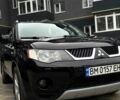 Черный Мицубиси Аутлендер, объемом двигателя 2.4 л и пробегом 210 тыс. км за 9900 $, фото 1 на Automoto.ua