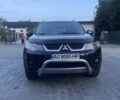 Черный Мицубиси Аутлендер, объемом двигателя 2.4 л и пробегом 290 тыс. км за 9500 $, фото 1 на Automoto.ua