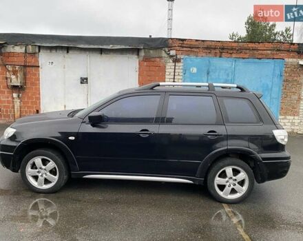 Черный Мицубиси Аутлендер, объемом двигателя 2 л и пробегом 306 тыс. км за 6500 $, фото 1 на Automoto.ua