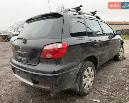 Черный Мицубиси Аутлендер, объемом двигателя 2 л и пробегом 200 тыс. км за 2999 $, фото 1 на Automoto.ua