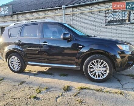 Черный Мицубиси Аутлендер, объемом двигателя 2.4 л и пробегом 199 тыс. км за 9000 $, фото 1 на Automoto.ua