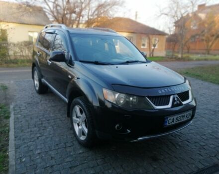 Черный Мицубиси Аутлендер, объемом двигателя 2.4 л и пробегом 228 тыс. км за 7850 $, фото 1 на Automoto.ua