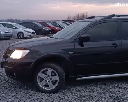 Черный Мицубиси Аутлендер, объемом двигателя 2 л и пробегом 271 тыс. км за 6940 $, фото 3 на Automoto.ua