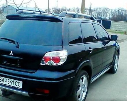 Черный Мицубиси Аутлендер, объемом двигателя 2.4 л и пробегом 150 тыс. км за 6300 $, фото 1 на Automoto.ua