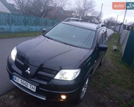 Чорний Міцубісі Аутлендер, об'ємом двигуна 2 л та пробігом 220 тис. км за 5599 $, фото 1 на Automoto.ua