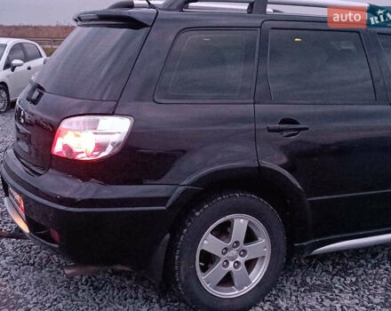 Чорний Міцубісі Аутлендер, об'ємом двигуна 2 л та пробігом 271 тис. км за 6940 $, фото 9 на Automoto.ua