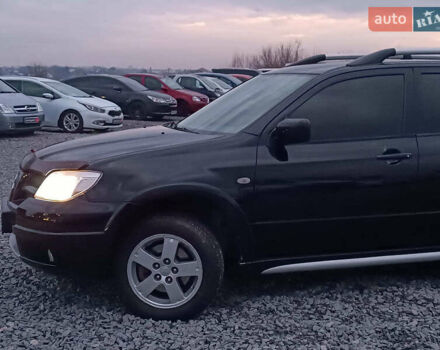 Чорний Міцубісі Аутлендер, об'ємом двигуна 2 л та пробігом 271 тис. км за 6940 $, фото 2 на Automoto.ua
