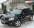 Черный Мицубиси Аутлендер, объемом двигателя 2 л и пробегом 117 тыс. км за 7990 $, фото 1 на Automoto.ua