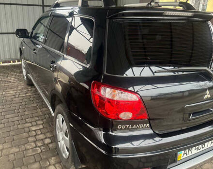 Черный Мицубиси Аутлендер, объемом двигателя 2 л и пробегом 130 тыс. км за 7500 $, фото 1 на Automoto.ua