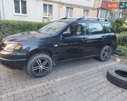 Черный Мицубиси Аутлендер, объемом двигателя 2 л и пробегом 245 тыс. км за 5500 $, фото 1 на Automoto.ua