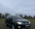 Черный Мицубиси Аутлендер, объемом двигателя 2.4 л и пробегом 230 тыс. км за 8800 $, фото 1 на Automoto.ua