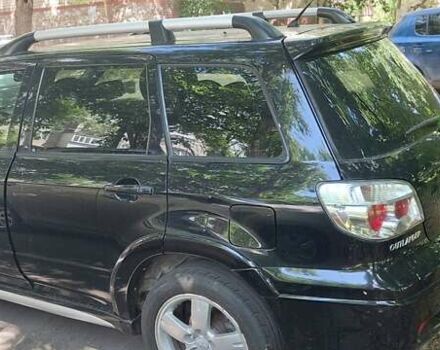 Черный Мицубиси Аутлендер, объемом двигателя 2.4 л и пробегом 150 тыс. км за 6300 $, фото 3 на Automoto.ua