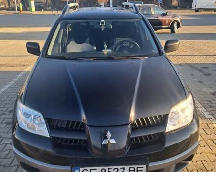 Черный Мицубиси Аутлендер, объемом двигателя 2 л и пробегом 190 тыс. км за 8000 $, фото 1 на Automoto.ua
