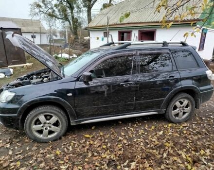 Черный Мицубиси Аутлендер, объемом двигателя 2.4 л и пробегом 149 тыс. км за 8800 $, фото 1 на Automoto.ua