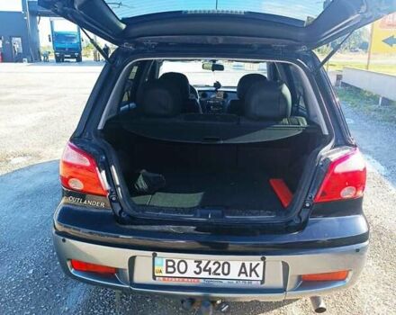 Черный Мицубиси Аутлендер, объемом двигателя 2 л и пробегом 235 тыс. км за 6900 $, фото 3 на Automoto.ua