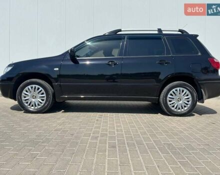 Черный Мицубиси Аутлендер, объемом двигателя 2 л и пробегом 236 тыс. км за 6699 $, фото 1 на Automoto.ua