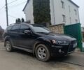 Черный Мицубиси Аутлендер, объемом двигателя 2 л и пробегом 235 тыс. км за 10300 $, фото 1 на Automoto.ua