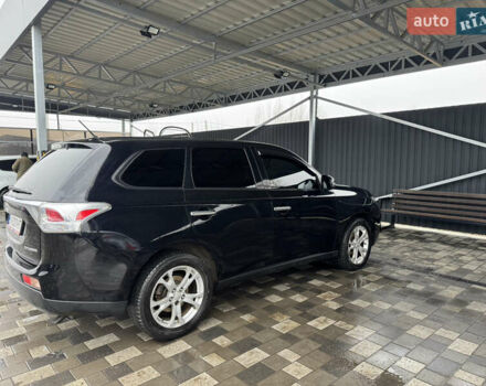 Черный Мицубиси Аутлендер, объемом двигателя 2.4 л и пробегом 150 тыс. км за 13700 $, фото 1 на Automoto.ua