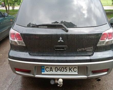 Черный Мицубиси Аутлендер, объемом двигателя 2 л и пробегом 320 тыс. км за 6300 $, фото 1 на Automoto.ua