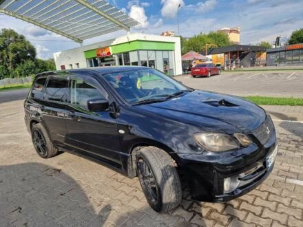Чорний Міцубісі Аутлендер, об'ємом двигуна 2 л та пробігом 143 тис. км за 8670 $, фото 1 на Automoto.ua