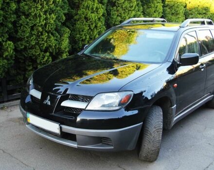 Черный Мицубиси Аутлендер, объемом двигателя 2 л и пробегом 251 тыс. км за 4990 $, фото 1 на Automoto.ua