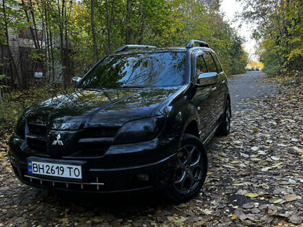 Черный Мицубиси Аутлендер, объемом двигателя 2.4 л и пробегом 267 тыс. км за 6900 $, фото 1 на Automoto.ua