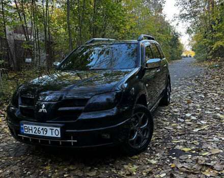 Черный Мицубиси Аутлендер, объемом двигателя 2.4 л и пробегом 267 тыс. км за 6900 $, фото 1 на Automoto.ua