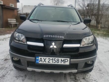 Черный Мицубиси Аутлендер, объемом двигателя 2.4 л и пробегом 150 тыс. км за 6300 $, фото 1 на Automoto.ua